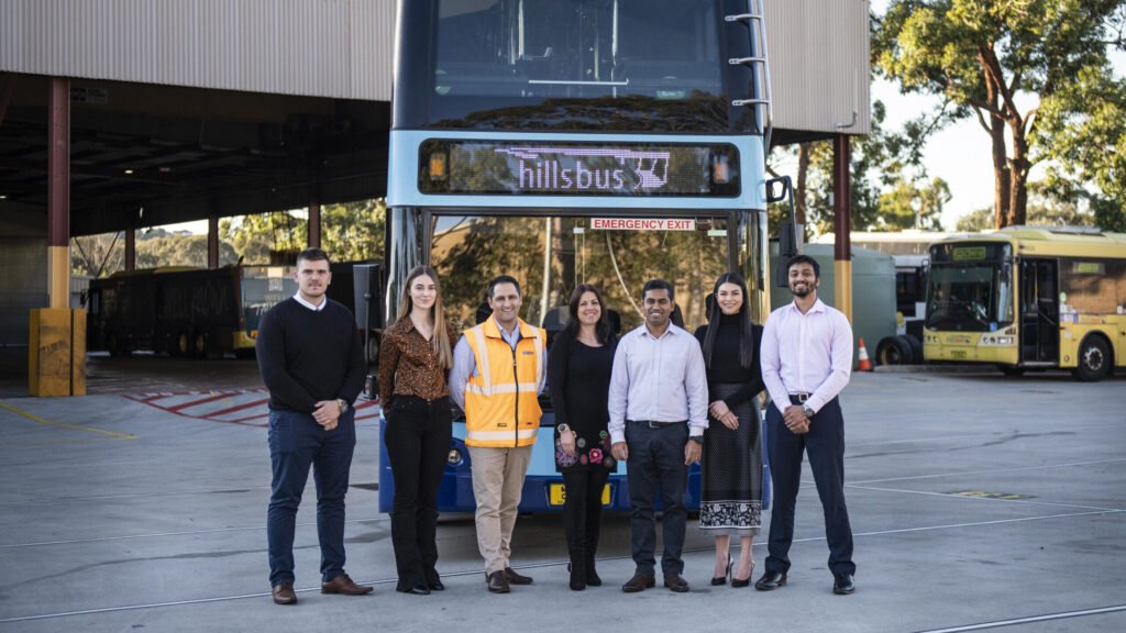 Staff Standing In Front Of A CDC NSW Bus