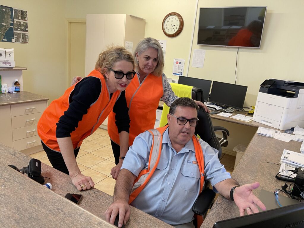 Viewing the Woopi Connect On Demand system: from left: Regional Australia Division Managers, Sharyn Sawyer and Rowena Van Malsen, with Forest Coach Lines Regional Manager North, Tony Mills